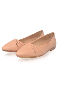 Pair of beige flat shoes on a white background