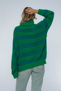 Person wearing a green striped sweater against a white background