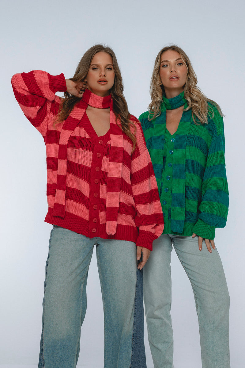 Two women wearing colorful checkered shirts against a white background