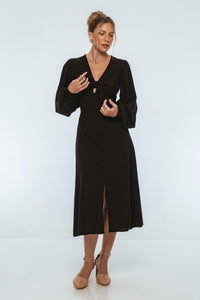 Woman wearing a black dress with a white background