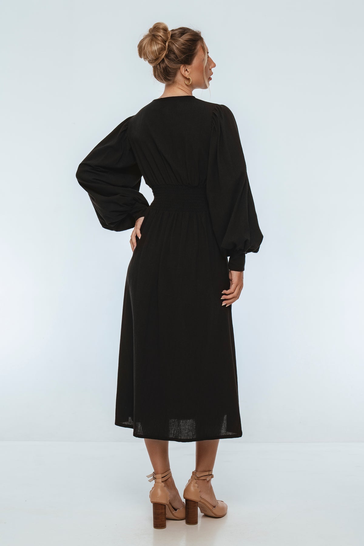 Woman wearing a black dress on a white background