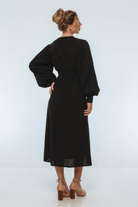 Woman wearing a black dress on a white background