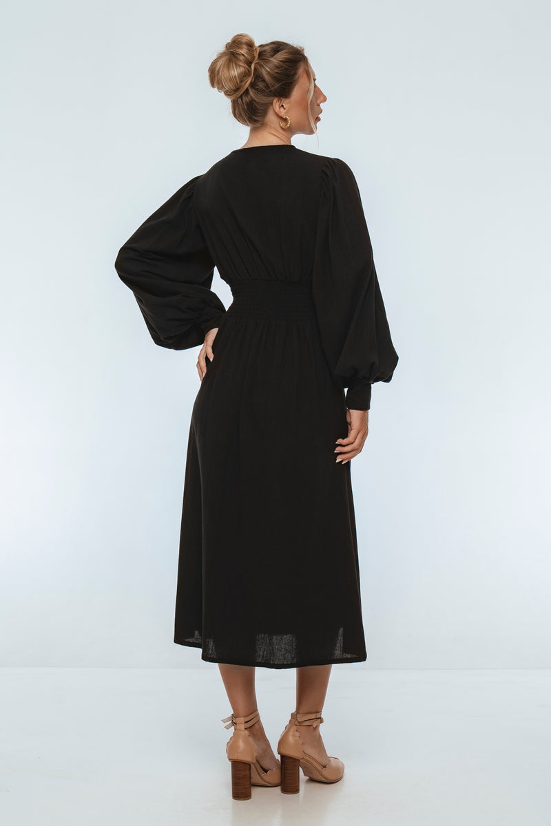 Woman wearing a black dress on a white background
