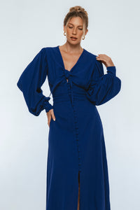 Woman wearing a blue dress with a white background