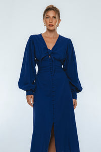 Woman wearing a blue dress against a white background