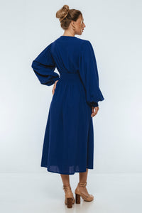 Woman wearing a blue dress on a white background