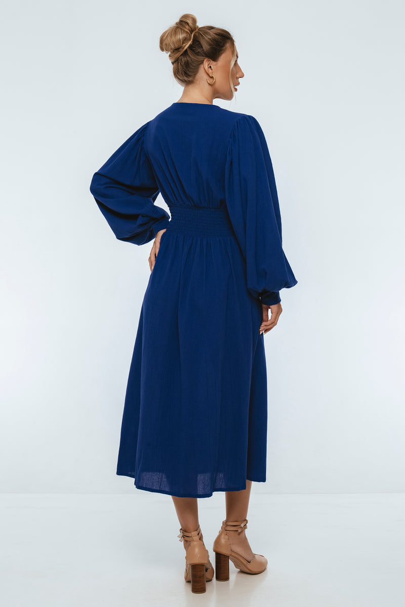 Woman wearing a blue dress on a white background