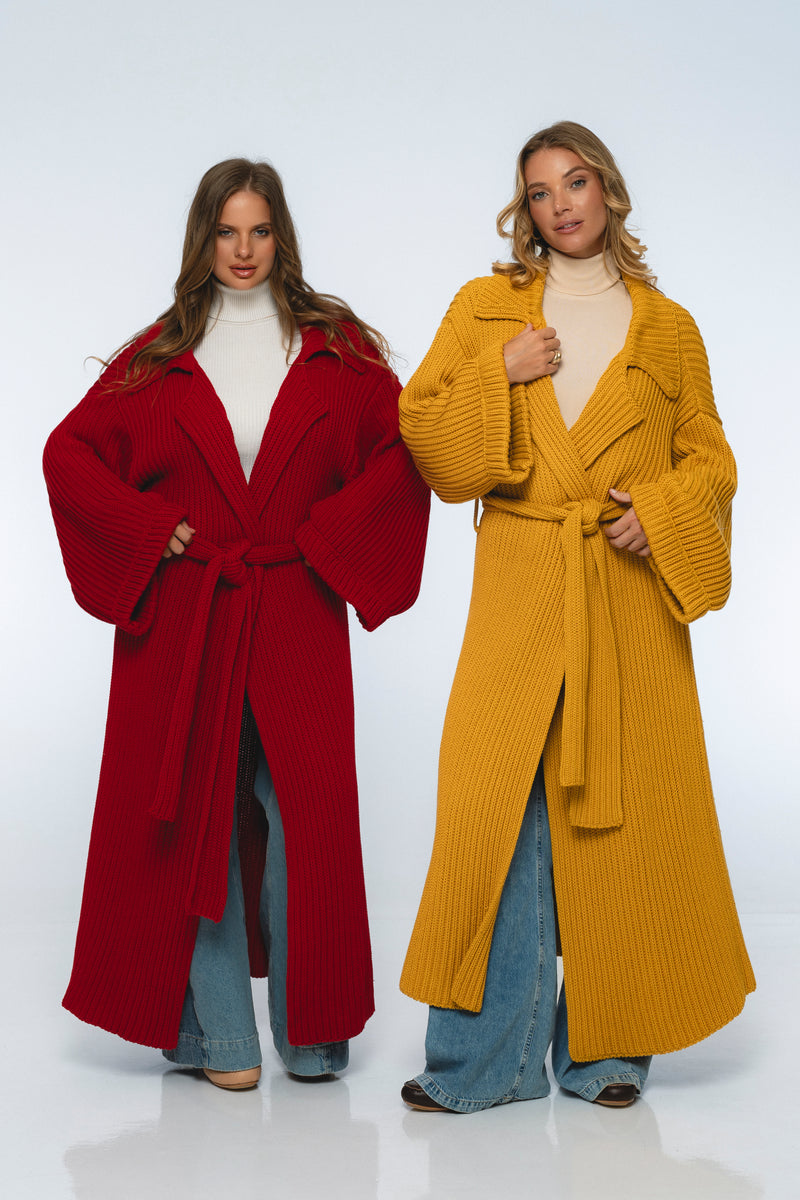 Two women wearing long coats, one red and one yellow, on a white background.
