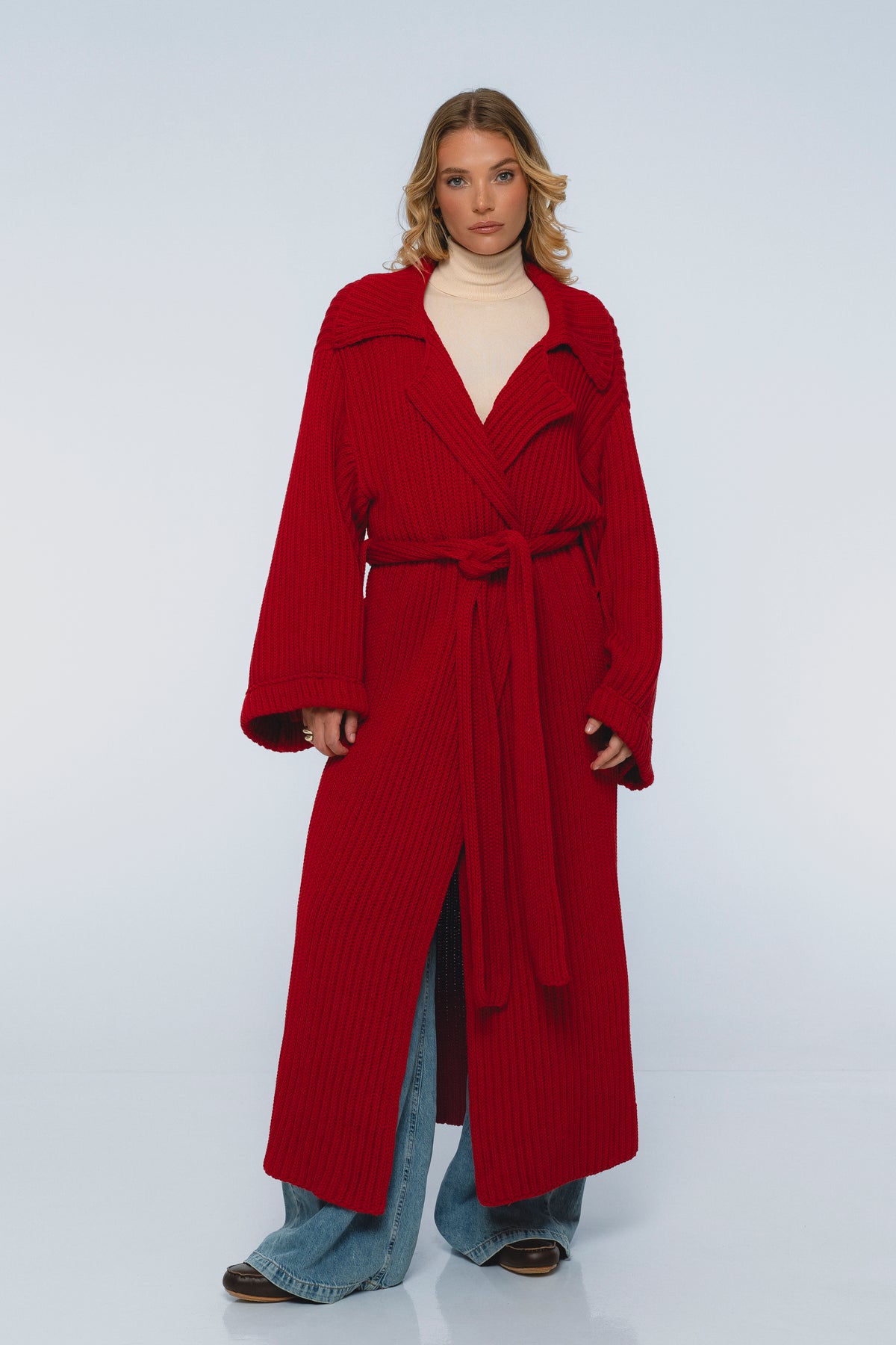 Woman wearing a red coat on a white background