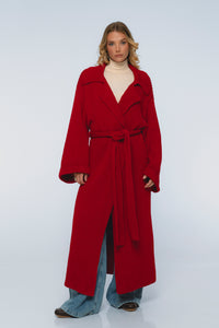 Woman wearing a red coat on a white background