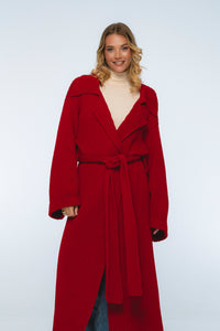 Woman wearing a red coat on a white background