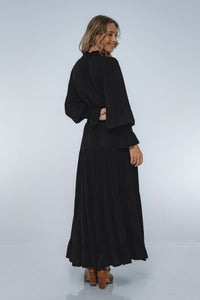 Woman wearing a black outfit on a white background