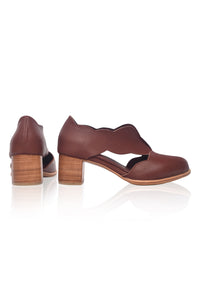 Brown leather shoes with wooden block heel on a white background
