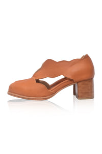 Brown leather shoe with a block heel on a white background