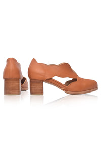 Pair of tan high-heeled shoes on a white background